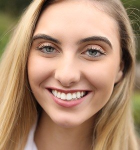 Teen girl smiling outdoors