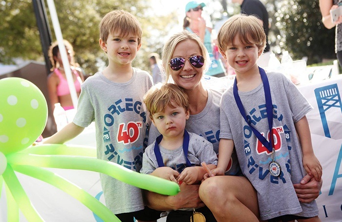 Team member and three kids at fun run