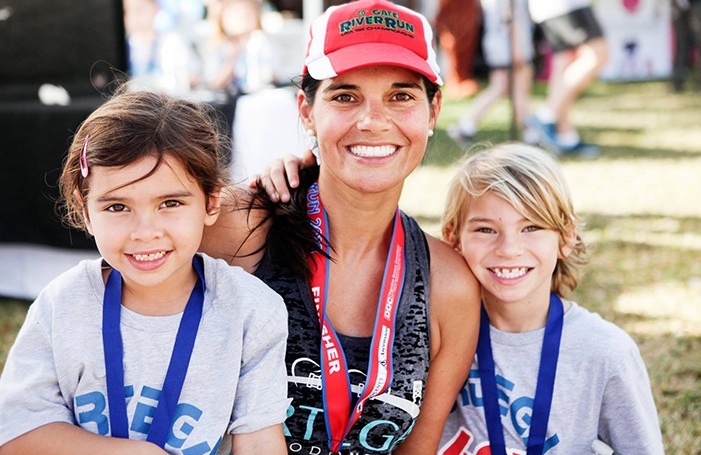 Team member and two kids at event