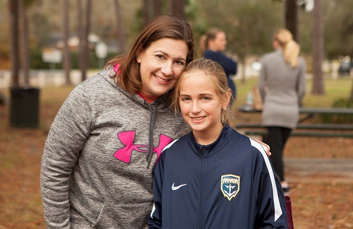 Team member and teen at community event