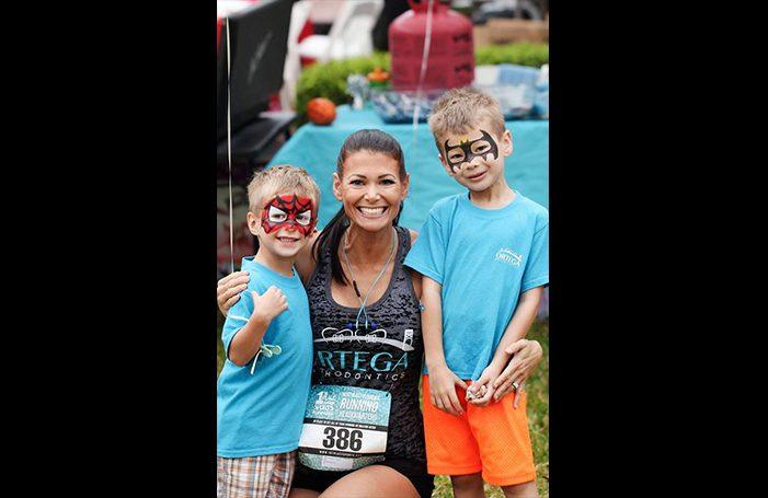 Team member and two kids at fun run