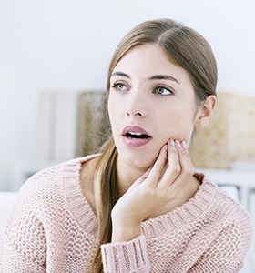 Woman holding jaw