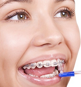 Teen cleaning between braces