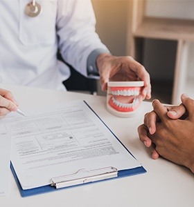 Orthodontist with patient chart and smile model