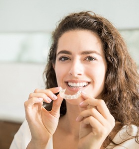 woman holding Invisalign