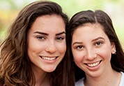 Mother and daughter smiling together