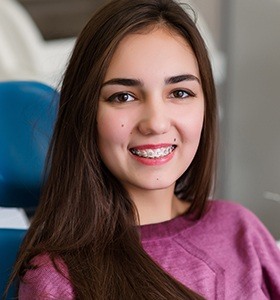 Teen in exam chair with braces