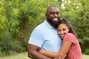 child hugging their parent and smiling