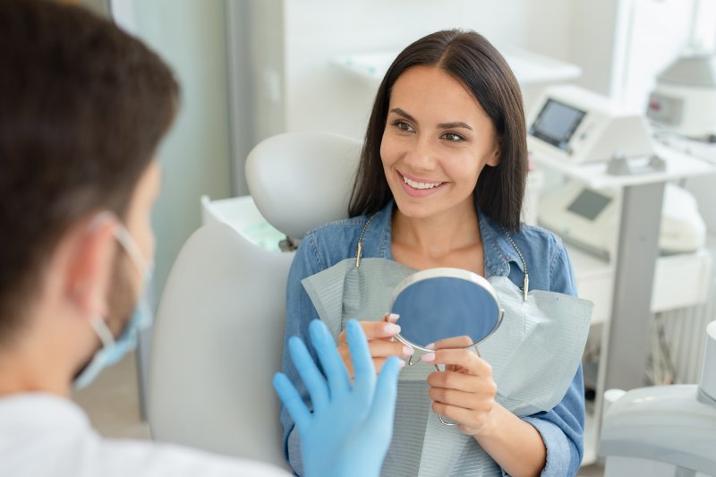 Woman smiling while talking to orthodontist