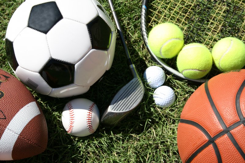 Assortment of different sports balls on field