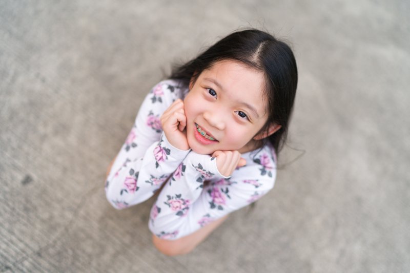 Small girl with braces looking up