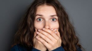 Surprised woman covering her mouth with her hands 